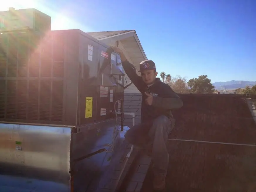 HVAC technician performing HVAC Inspection on a rooftop unit in Montgomery